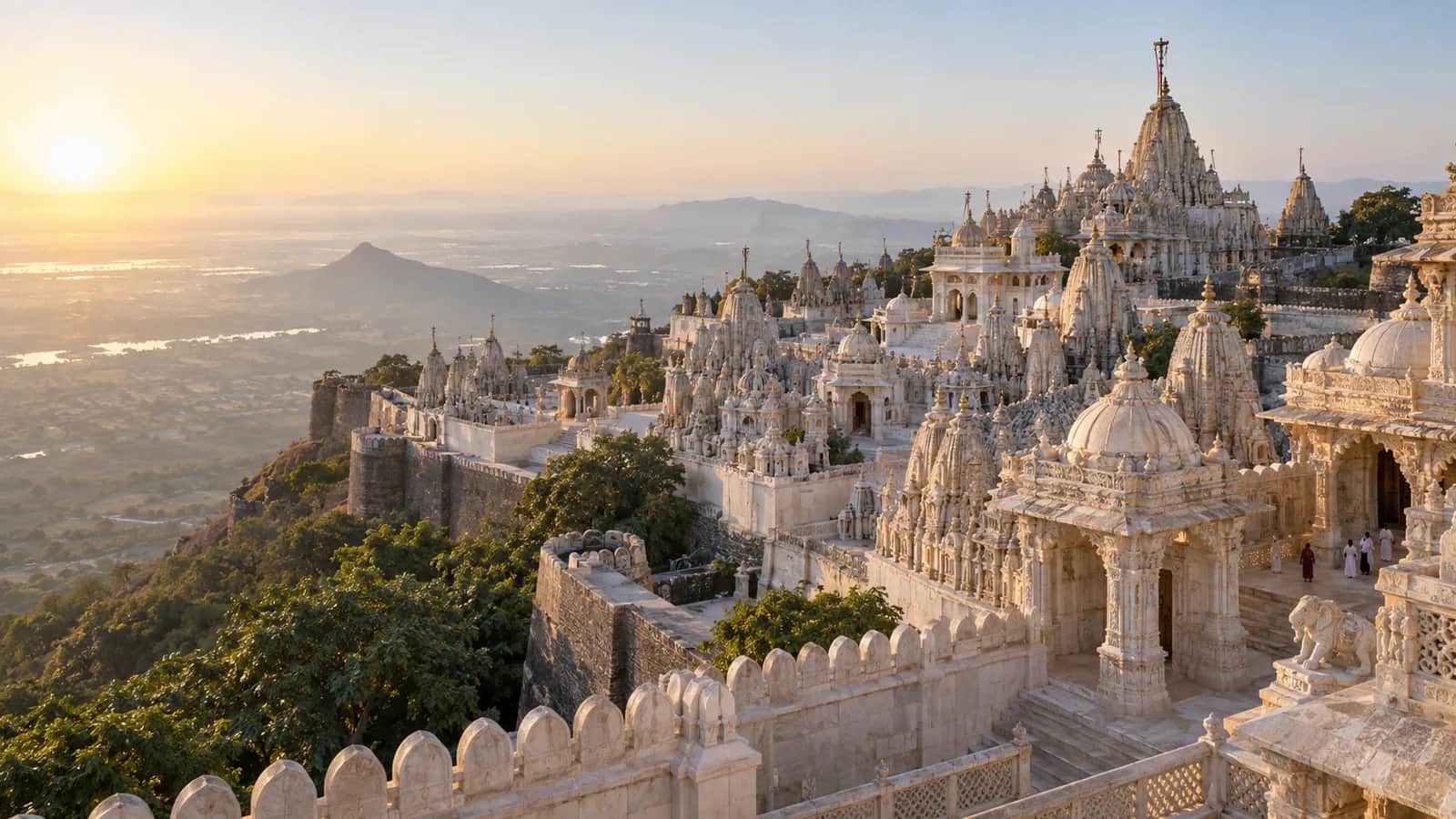 White marble Jain temple spires across Shatrunjaya Hill at Palitana in the early morning
