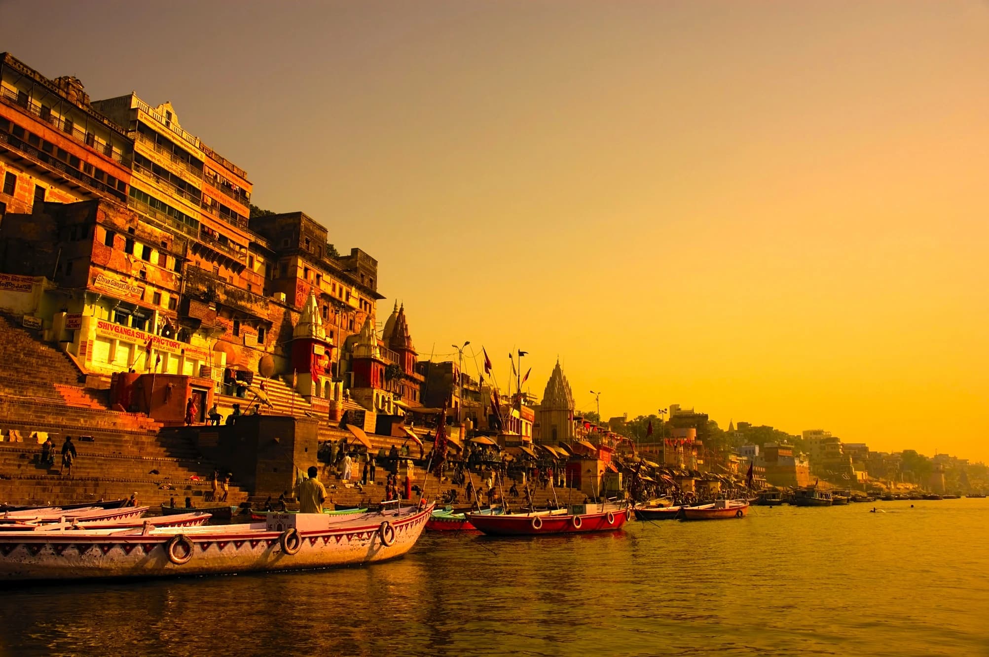 Boats resting along the Varanasi ghats at sunset